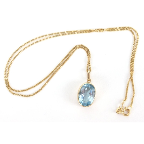 2557 - 9ct gold blue topaz pendant on a 9ct gold necklace, the pendant 2.5cm in length, approximate weight ... 