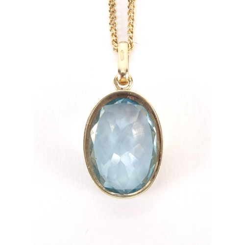 2557 - 9ct gold blue topaz pendant on a 9ct gold necklace, the pendant 2.5cm in length, approximate weight ... 