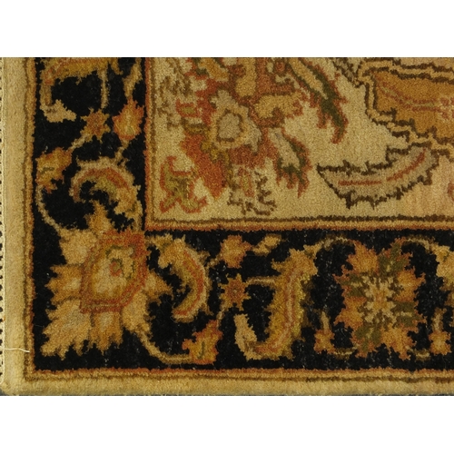 2015 - Tabriz carpet runner with stylised floral design, with black boarder on a mainly cream ground, 305cm... 