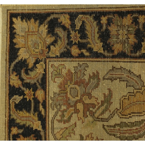 2015 - Tabriz carpet runner with stylised floral design, with black boarder on a mainly cream ground, 305cm... 