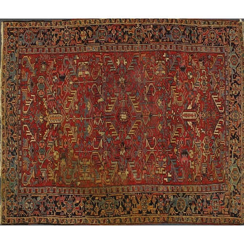 2025 - Persian Heriz carpet having an all over floral design, 322cm x 235cm