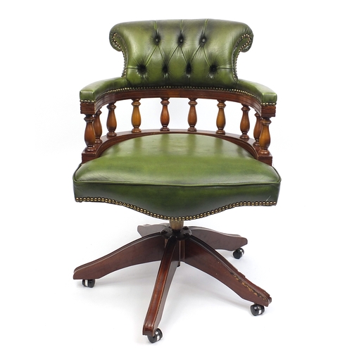 2021 - Mahogany swiveling Captains chair with green leather upholstery