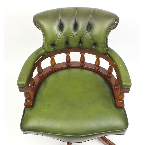2021 - Mahogany swiveling Captains chair with green leather upholstery