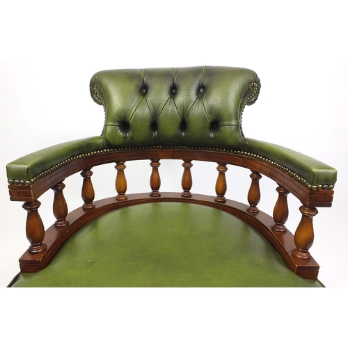 2021 - Mahogany swiveling Captains chair with green leather upholstery