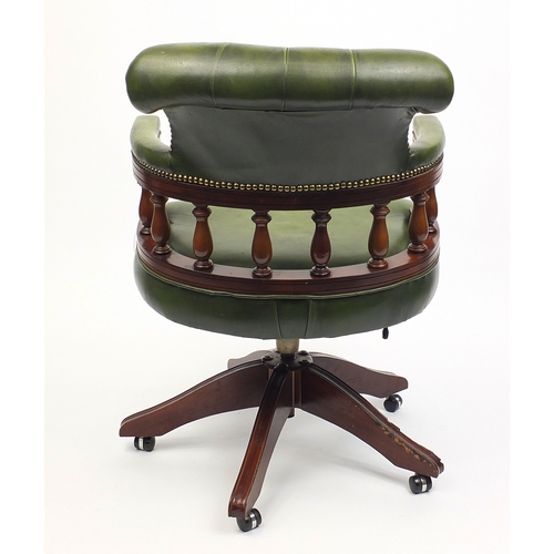 2021 - Mahogany swiveling Captains chair with green leather upholstery