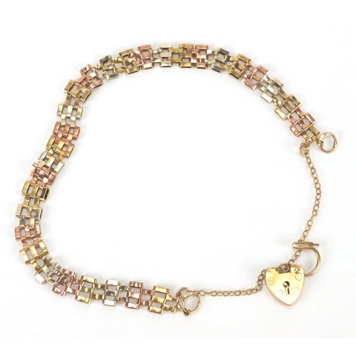 2529 - 9ct gold three tone gate bracelet with love heart padlock, 18cm in length, approximate weight 4.3g