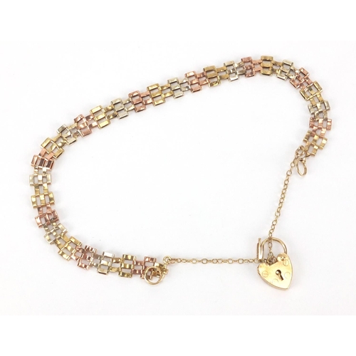 2529 - 9ct gold three tone gate bracelet with love heart padlock, 18cm in length, approximate weight 4.3g