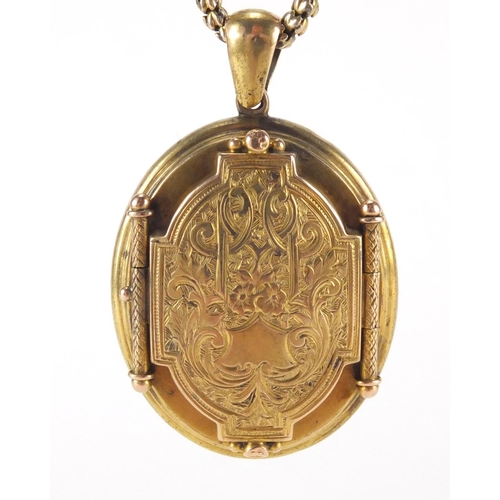 2592 - Victorian gilt metal locket with engraved decoration on a gold coloured necklace, the locket 5cm in ... 