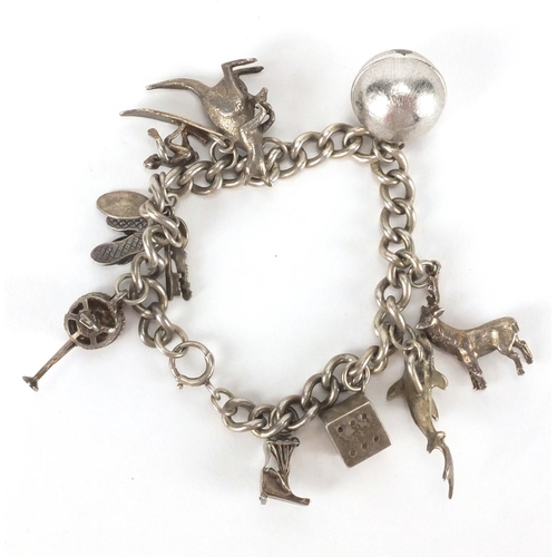 2624 - Silver charm bracelet with a selection of mostly silver charms including a stag, dice, watering can,... 