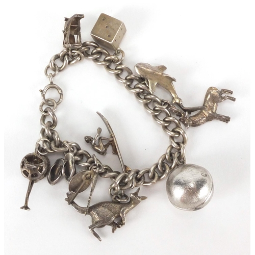 2624 - Silver charm bracelet with a selection of mostly silver charms including a stag, dice, watering can,... 