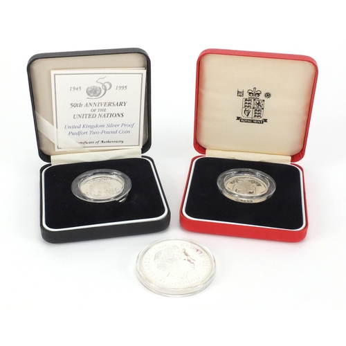 2457 - Two silver proof Piedfort two pound coins together with a 2001 Britannia one ounce silver two pound