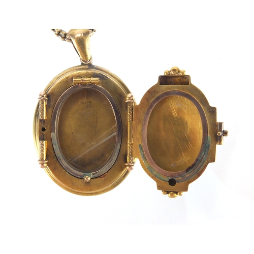 2592 - Victorian gilt metal locket with engraved decoration on a gold coloured necklace, the locket 5cm in ... 