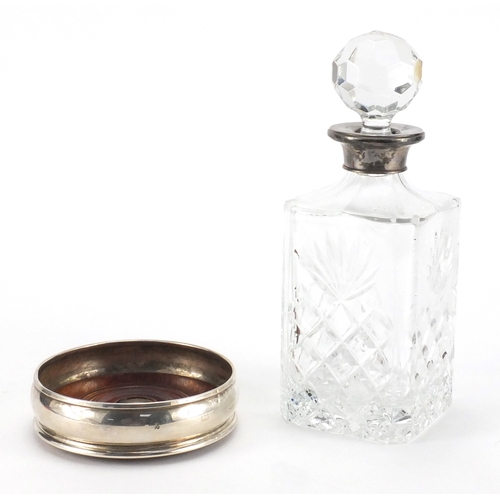 2420 - 2000 Millennium silver wine coaster together with a glass decanter with silver collar, the decanter ... 