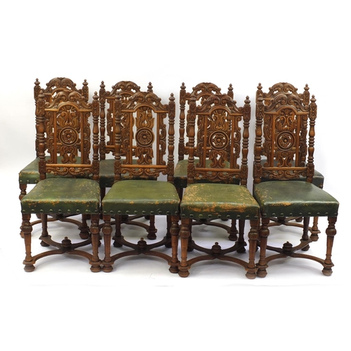 17 - Set of eight profusely carved oak dining chairs, with green leather seats and X stretchers, 102cm hi... 