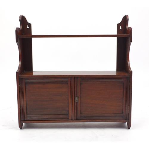 34 - Mahogany wall hanging cupboard fitted with a shelf above a pair of cupboard doors, 60cm H x 59cm W x... 