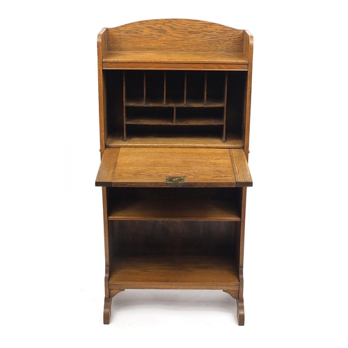 4 - Oak Arts & Crafts students bureau with a fall enclosing a fitted interior, 120cm high