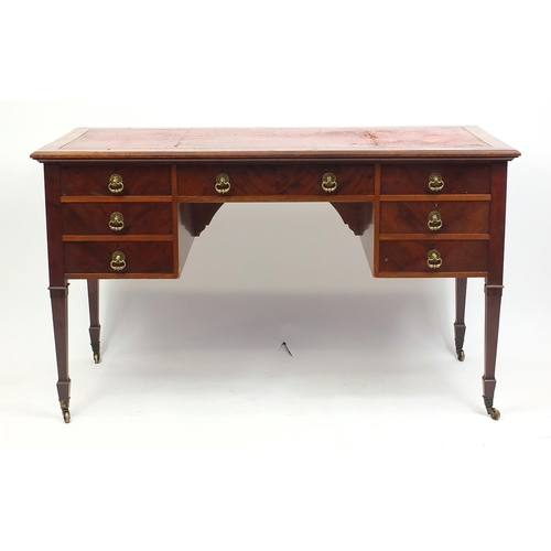 11 - Mahogany desk with tooled leather top above an arrangement of seven drawers on tapering legs, 77cm H... 