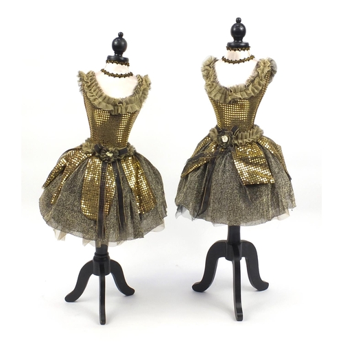 2052 - Pair of children's dresses on mannequins, each 120cm high