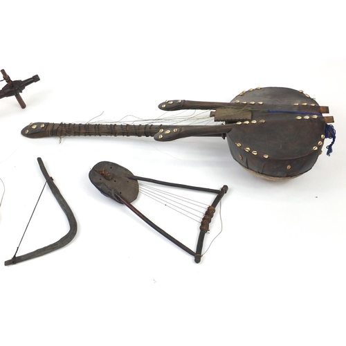 578 - African musical instruments including two Krar from Ethiopia and a Kora with cowrie shells, the larg... 