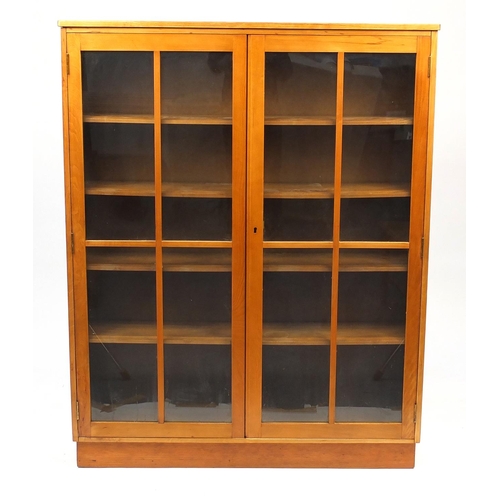 46 - Light wood book case, fitted with a pair of glazed doors enclosing four adjustable shelves, 152cm H ... 