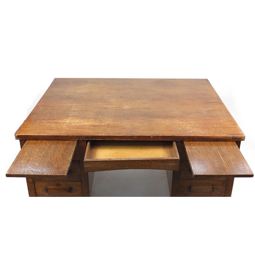 6 - Oak partners desk fitted with a series of drawers, 77cm H x 153cm W x 122cm D