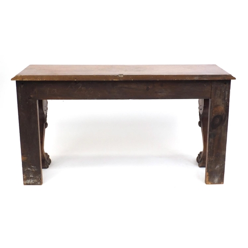 2038 - Carved oak console table fitted with two frieze drawers, raised on paw feet, one drawer stamped T Wi... 