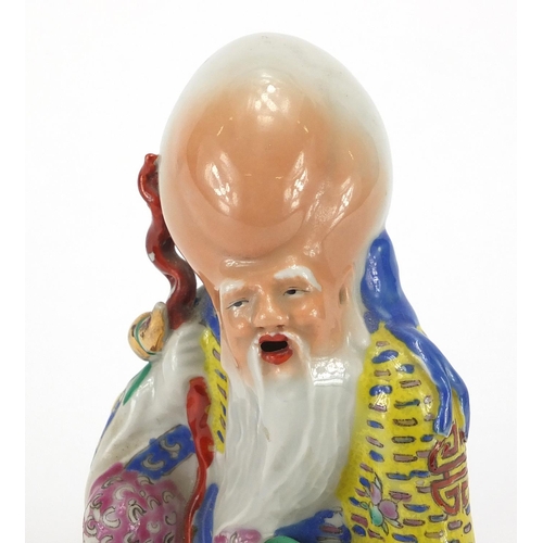434 - Chinese porcelain figure of an elder, hand painted in the famille rose palette, impressed four figur... 