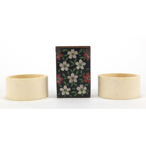 517 - Pair of Chinese ivory napkin rings together with a cloisonné matchbox holder, the napkin rings hand ... 