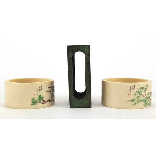 517 - Pair of Chinese ivory napkin rings together with a cloisonné matchbox holder, the napkin rings hand ... 