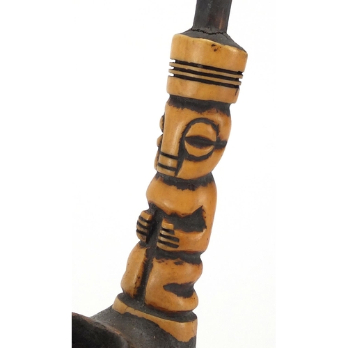 564 - African figural clay pipe with carved bone stem, 31.5cm high