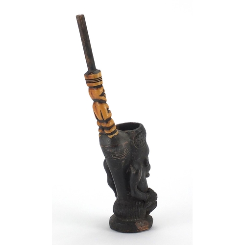 564 - African figural clay pipe with carved bone stem, 31.5cm high