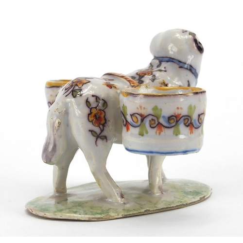 597 - Rouen faience glazed pottery double salt in the form of a ram, hand painted with flowers on a grassy... 