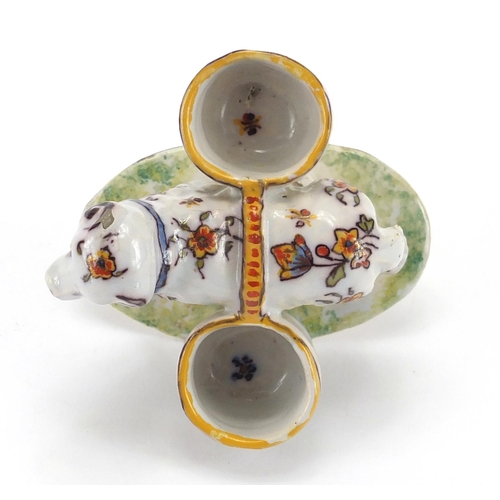 597 - Rouen faience glazed pottery double salt in the form of a ram, hand painted with flowers on a grassy... 