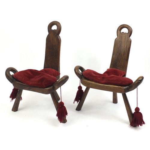 2047 - Two antique three legged stools red velvet cushions, each 68cm high
