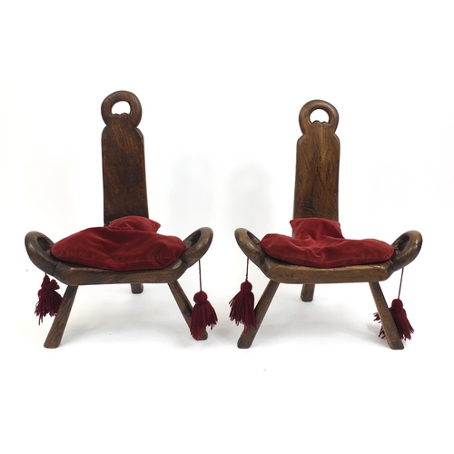 2047 - Two antique three legged stools red velvet cushions, each 68cm high