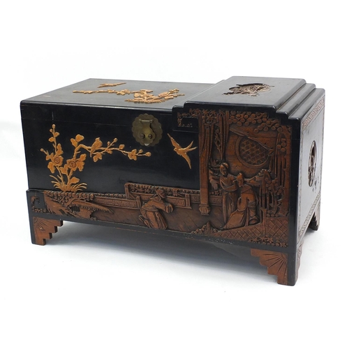 29 - Oriental camphorwood chest with ebonised and carved decoration, 60cm H x 104cm W