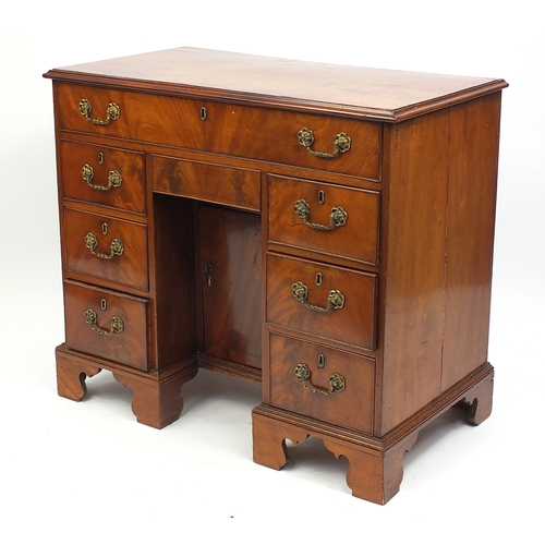 2014 - Victorian walnut kneehole desk fitted with an arrangement of eight drawers and a central cupboard do... 