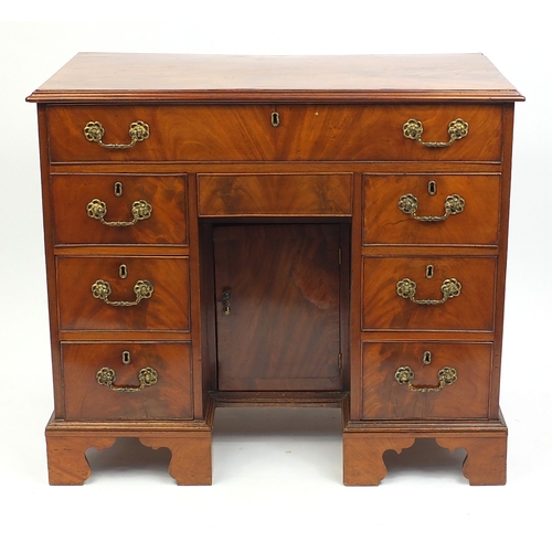 2014 - Victorian walnut kneehole desk fitted with an arrangement of eight drawers and a central cupboard do... 