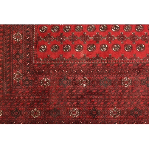 2030 - Rectangular Afghan carpet having an all over geometric design onto a red ground, 390cm x 310cm