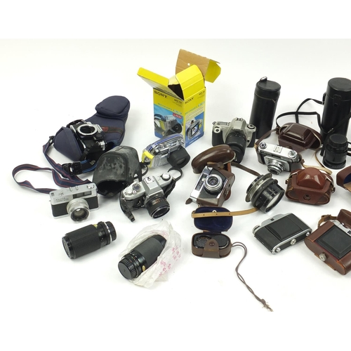 213 - Vintage and later cameras and accessories including Canon, Minolta and Praktica