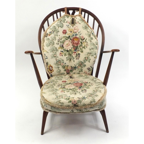 57 - Ercol stick back easy chair with floral upholstered cushions, 94cm high