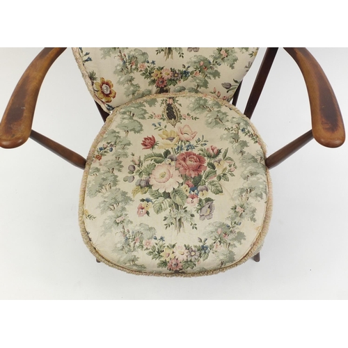 57 - Ercol stick back easy chair with floral upholstered cushions, 94cm high