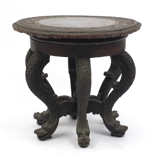 574 - 19th century Anglo Indian circular hardwood table with carved serpent legs, the swivelling top carve... 