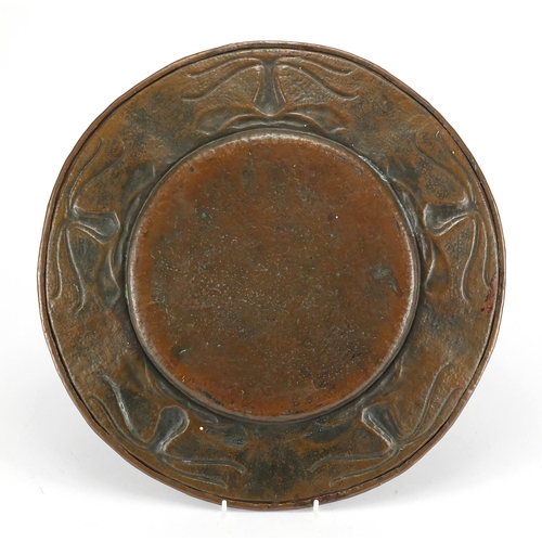 704 - Arts & Crafts copper charger, the border embossed with stylised flowers, 40cm in diameter