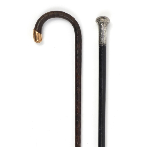 130 - Victorian ebonised walking cane with silver pommel, together with a 15ct gold mounted example, the l... 