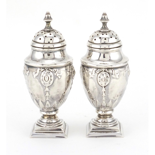 735 - Pair of Victorian silver urn and cover casters, embossed with swags, HW London 1891, 10cm high, appr... 