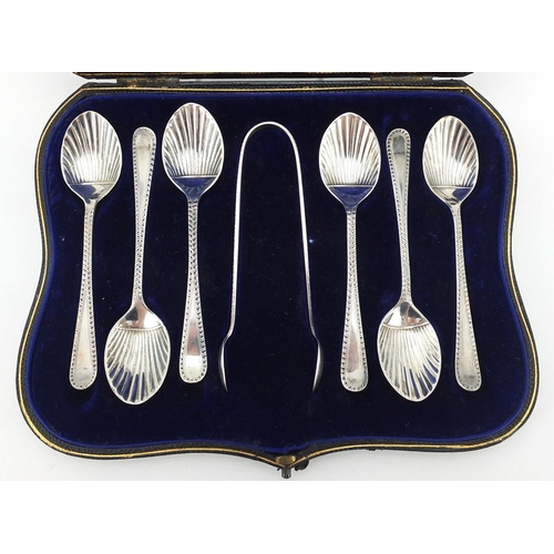 783 - Set of six silver teaspoons with shell shaped bowls and sugar tongs, indistinct makers mark London 1... 