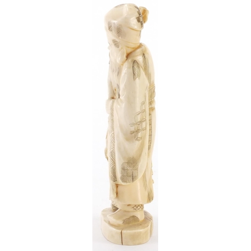 505 - Japanese carved ivory okimono of an elder holding a staff with a child, character marks to the base,... 