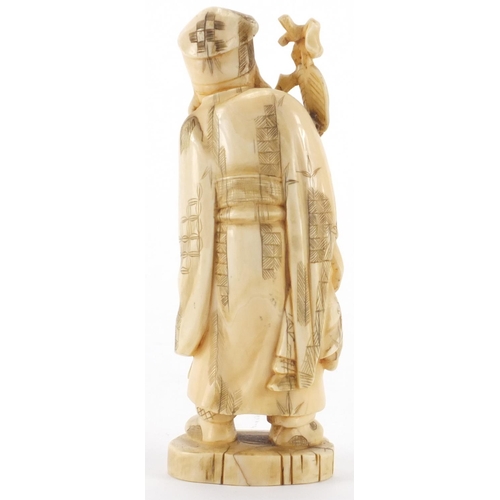 505 - Japanese carved ivory okimono of an elder holding a staff with a child, character marks to the base,... 