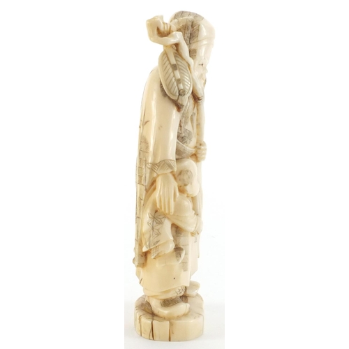 505 - Japanese carved ivory okimono of an elder holding a staff with a child, character marks to the base,... 